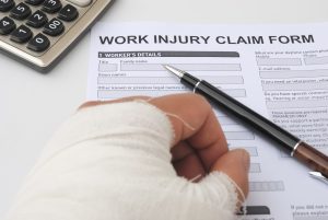 Injured person filling out a work injury claim form