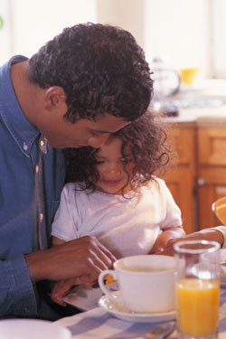 Father and daughter easting breakfast